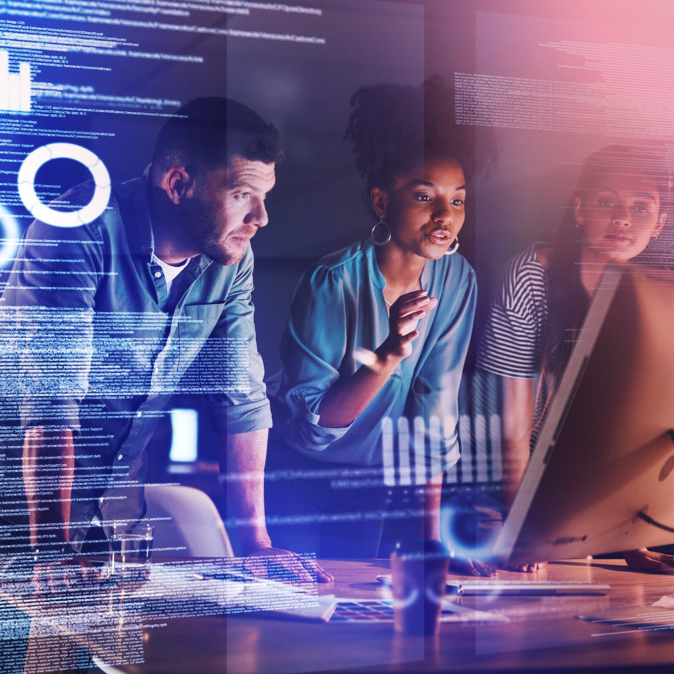 Three diverse people collaborating in a high-tech workspace with digital data overlays and a computer screen.