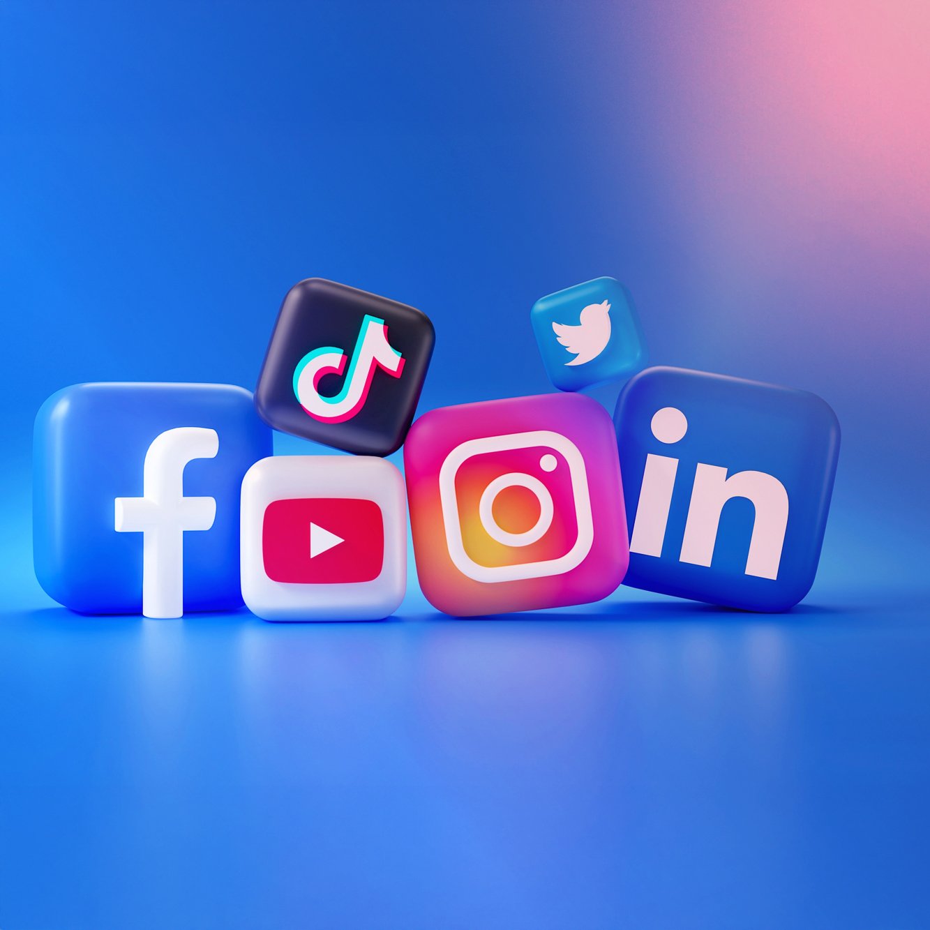 Colorful 3D social media icons for Facebook, YouTube, TikTok, Instagram, Twitter, and LinkedIn arranged on a vibrant blue background.