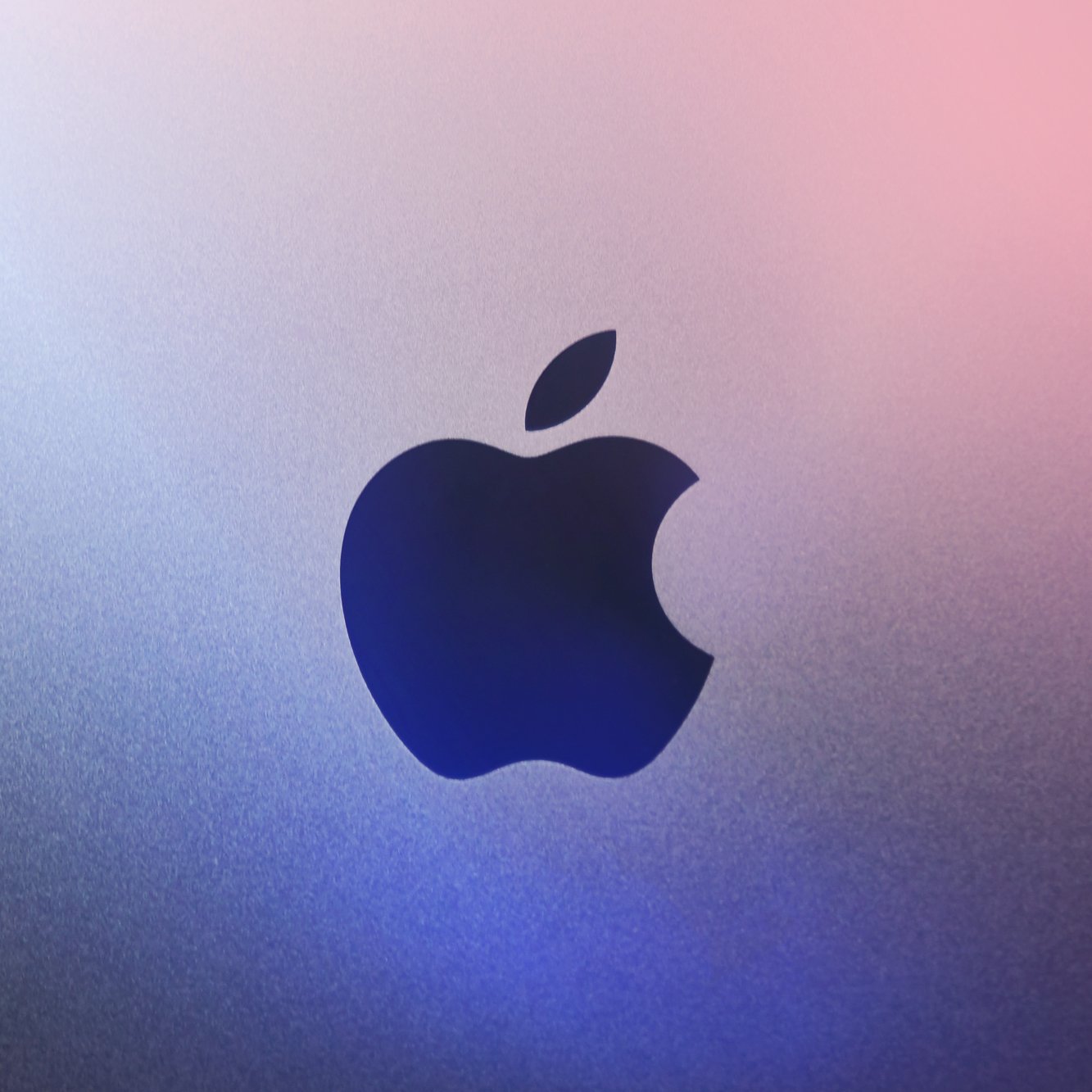 Apple logo in gradient background symbolizing sound and visual synergy.