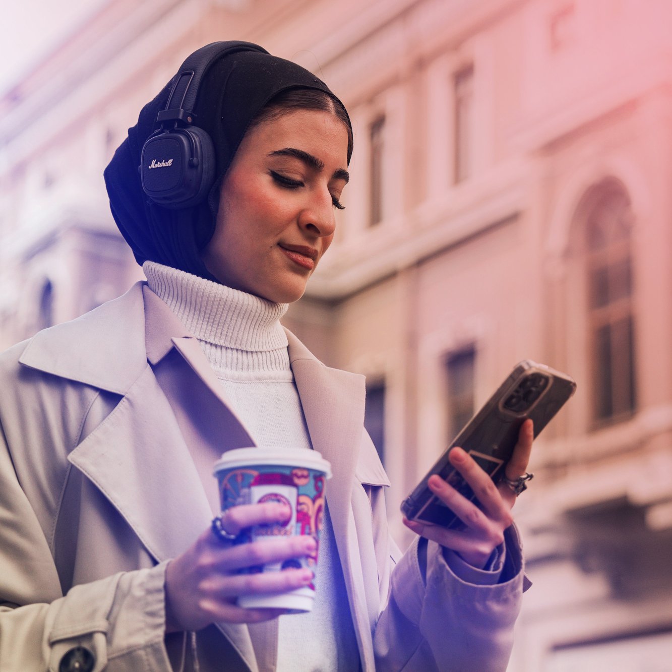 Woman with headphones and phone, representing strategic integration of sound and brand goals.