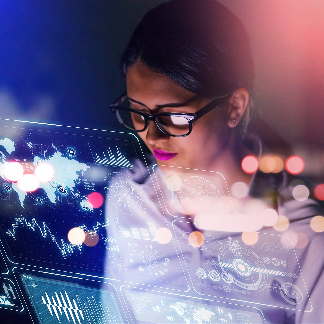 Woman with glasses looking at futuristic digital data projections with world map and charts