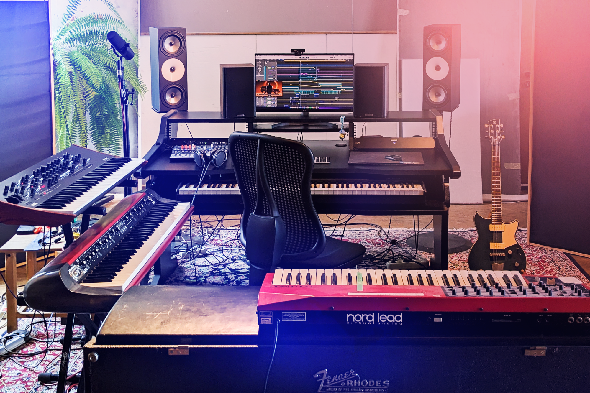 Professional music studio with instruments and monitors representing artist talent network.
