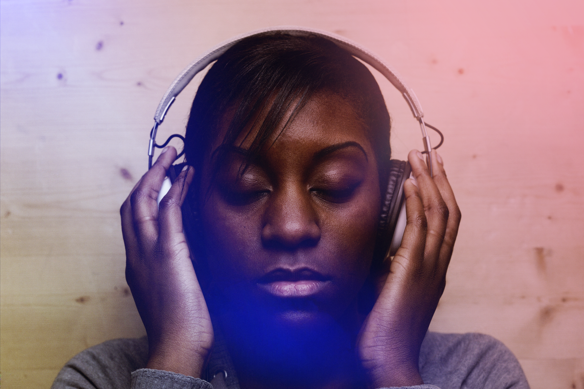 Woman wearing headphones representing amp’s blog on branding, culture, and sound innovation.